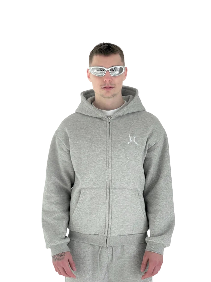 Person wearing a gray hoodie with a logo on a white background
